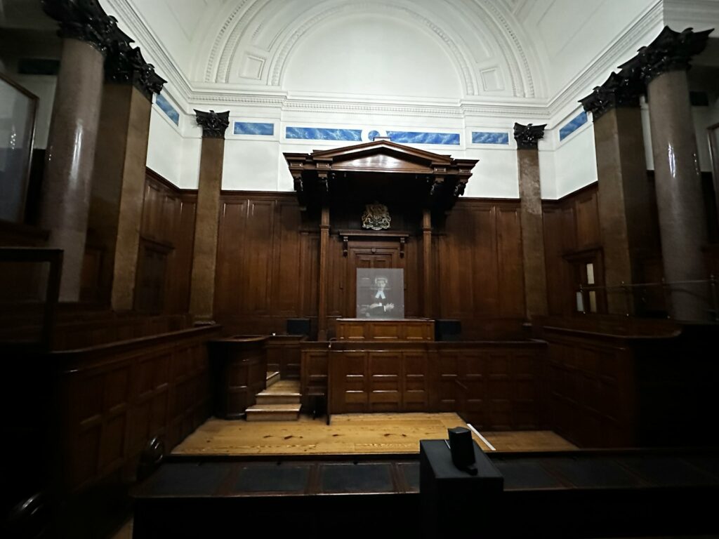 Empty courtroom with wooden panelling and columns